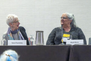 Sara Paretsky and Mysti Berry chatting at a panel on social justice and good crime writing